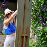 painting behind an easel during painting holiday in france